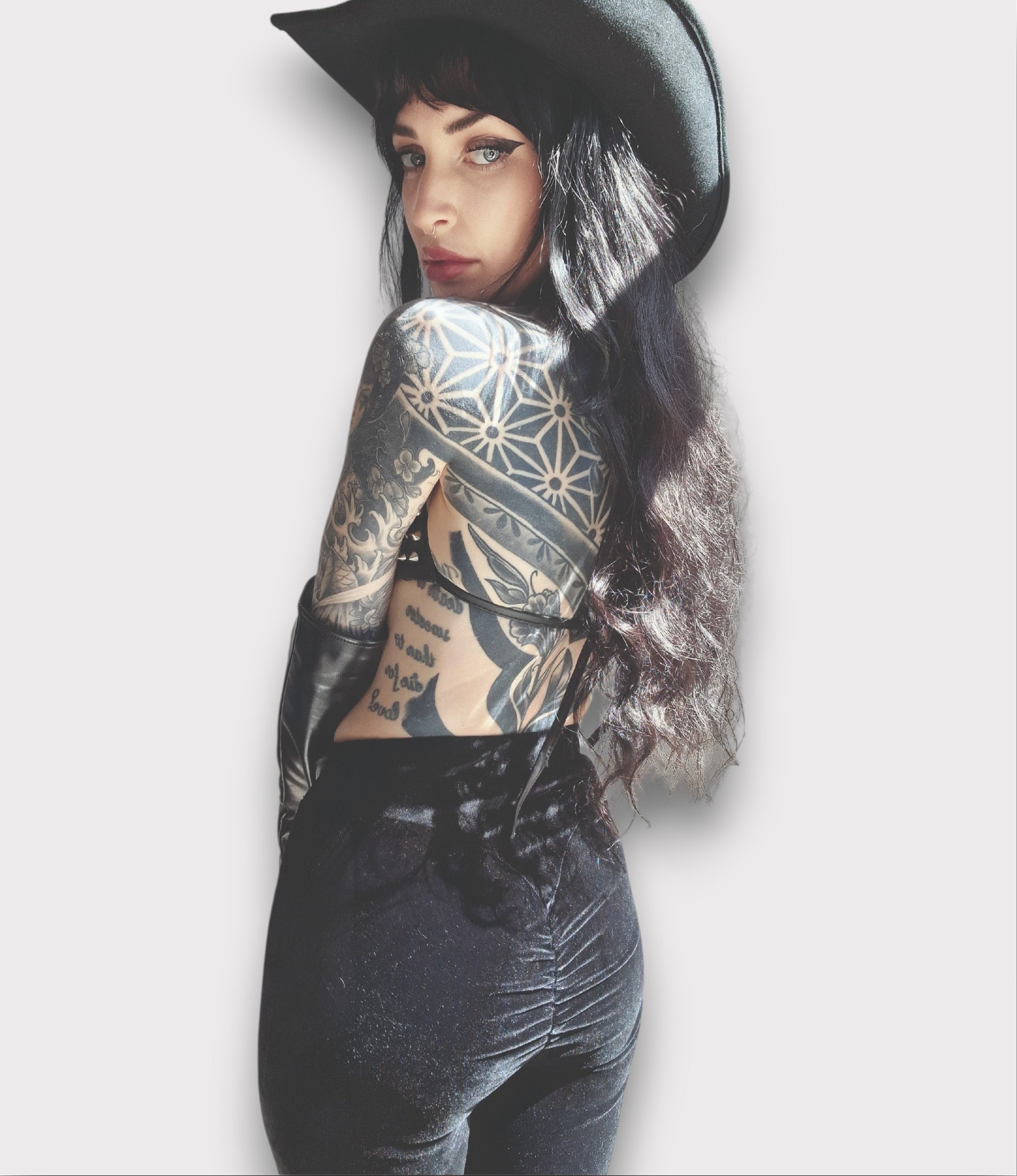 Black velvet bell bottom pants on a light gray background